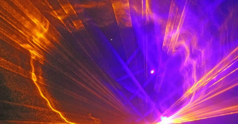 Abstract orange and purple light beams converging across a textured dark background.