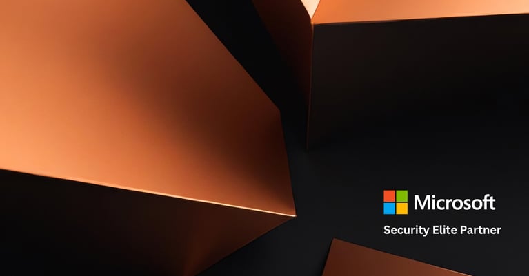 Abstract 3D geometric shapes in Microsoft brand colours with the Microsoft logo and "Microsoft Security Elite Partner" text on a dark background.