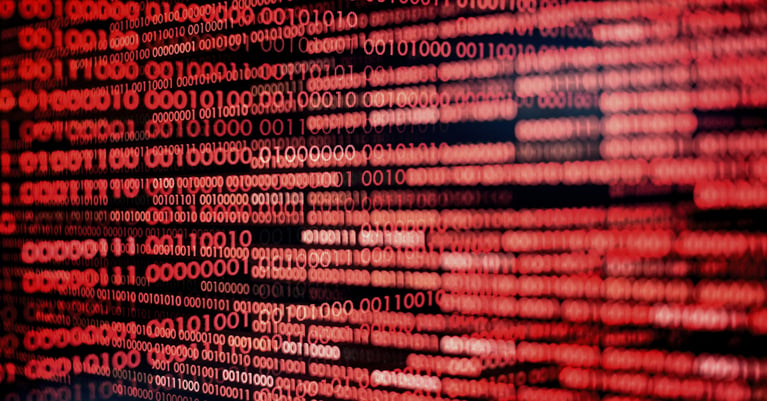 Red binary code representing a ransomware attack and the growing cyber threat landscape.