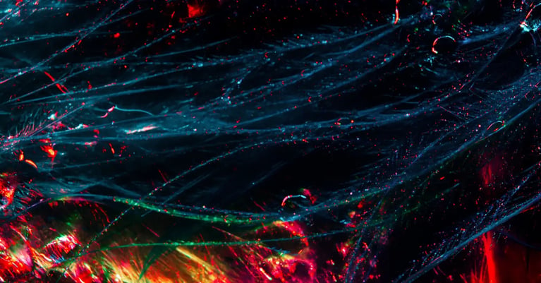 Abstract strands of blue, green and red light intertwine against a dark background, representing connected cyber security systems.